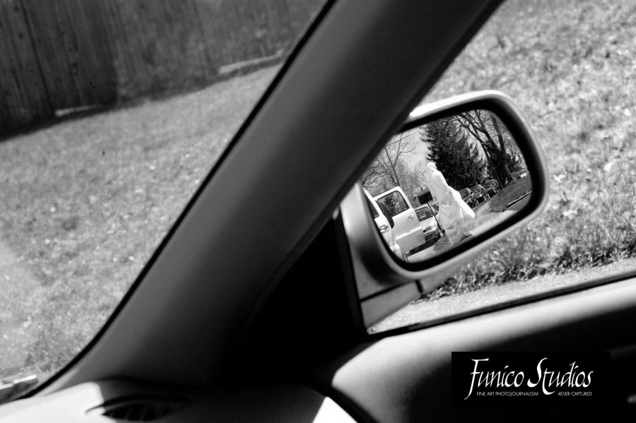reflection of bride in side view mirror